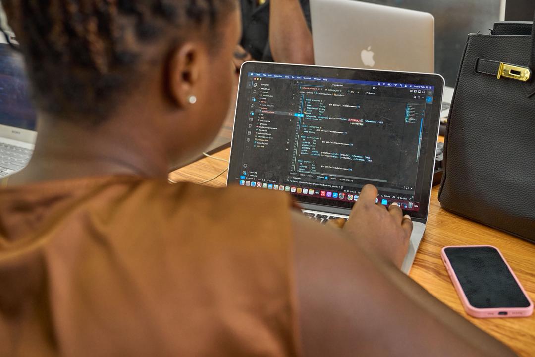 A developer at New Vision Creatives writing code