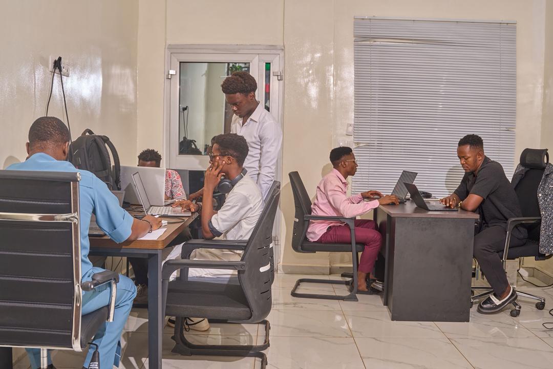 New Vision Creatives staff collaborating at their workstations